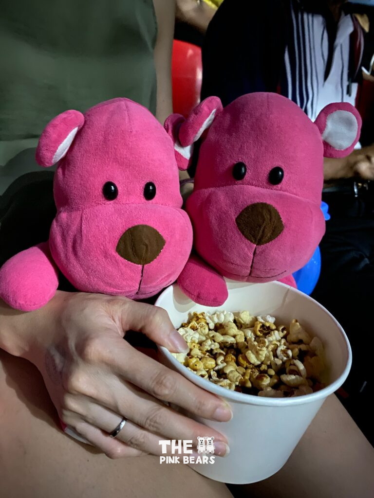 two pink bears with popcorn